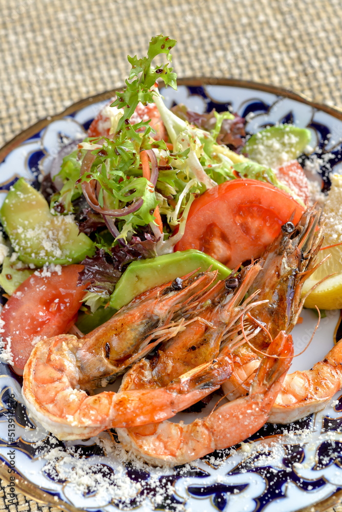 fresh salad with shrimp on a patterned plate macro vertical photo fresh salad with shrimp on a patterned plate macro vertical photo