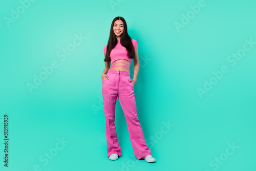 Photo of cheerful nice lady standing look in camera smiling isolated on aquamarine color background