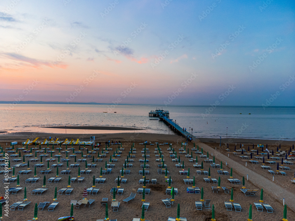 Obraz premium Sunrise in Lignano Sabbiadoro seen from above. From the sea to the lagoon, the city of holidays