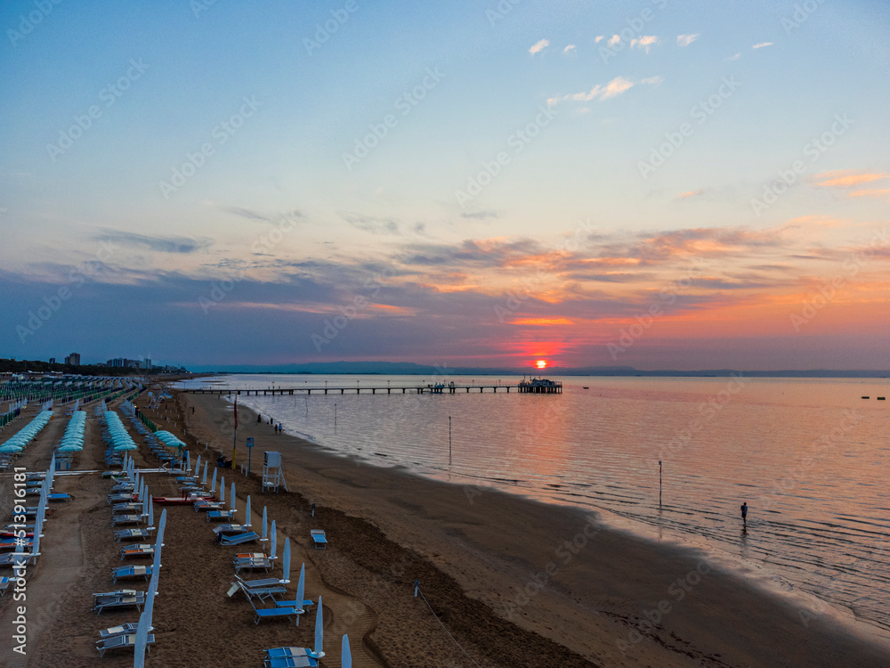 Sunrise in Lignano Sabbiadoro seen from above. From the sea to the lagoon, the city of holidays