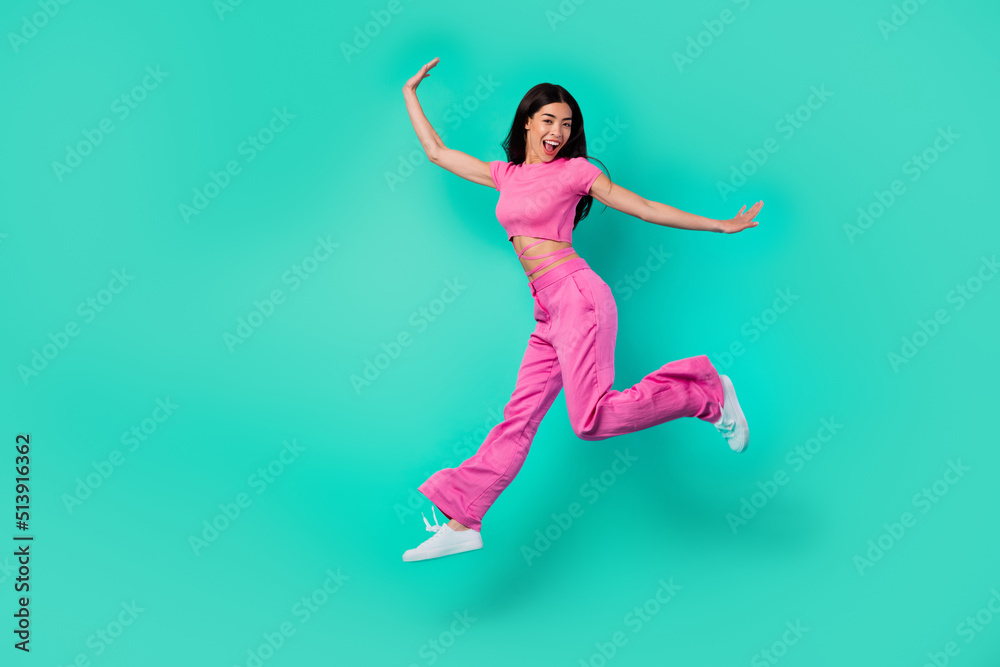 Full size photo of cheerful lady jumping high enjoy discounts wear trend stylish outfit isolated cyan color background
