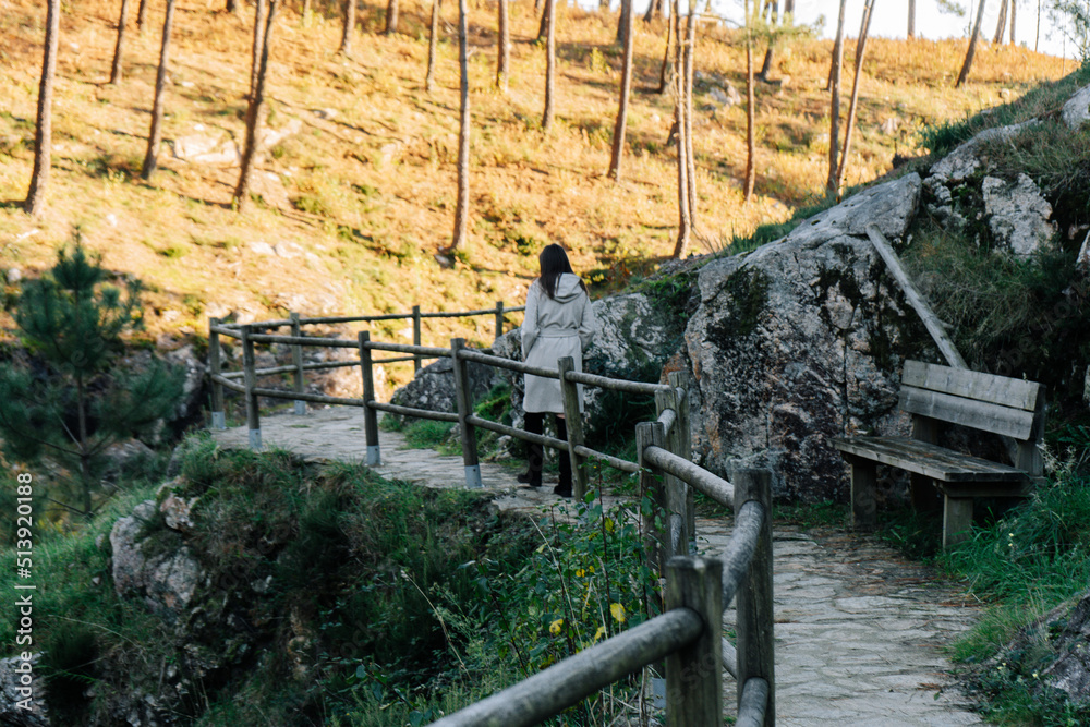 Young woman walking on a mountain route Young woman walking on a mountain route