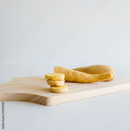 baroa potatoes over wooden table on white background photo