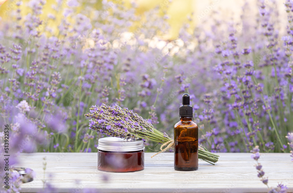 Amber essential lavender oil bottle. Violet lavendar field in Provence. Amber essential lavender oil bottle. Violet lavendar field in Provence.