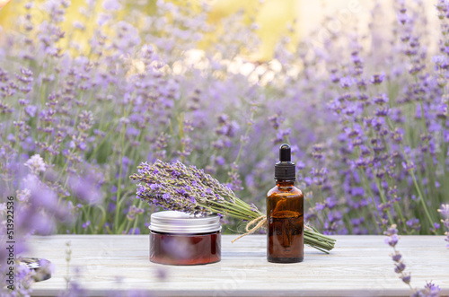 Amber essential lavender oil bottle. Violet lavendar field in Provence.