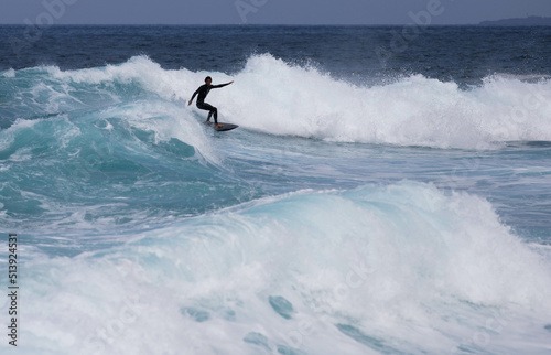 PUERTO DE SANTIAGO, TENERIFE - JUNE 2022: surfer riding the waves in Tenerife