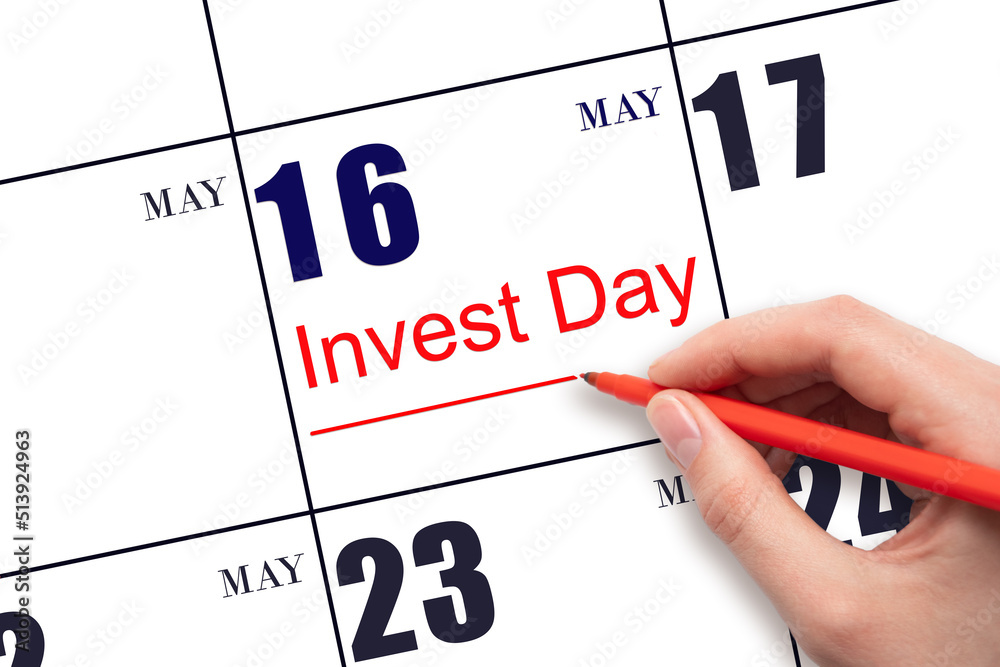 Hand drawing red line and writing the text Invest Day on calendar date May 16. Business and financial concept. Hand drawing red line and writing the text Invest Day on calendar date May 16. Business and financial concept.