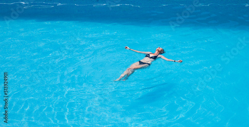 top view of woman floating in swimming pool