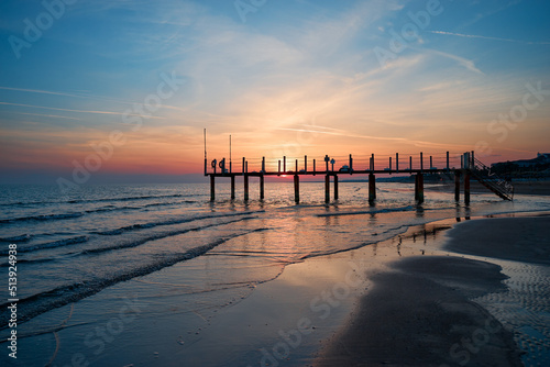 Beautiful sunset on sea beach. Sky is reflecting at water.