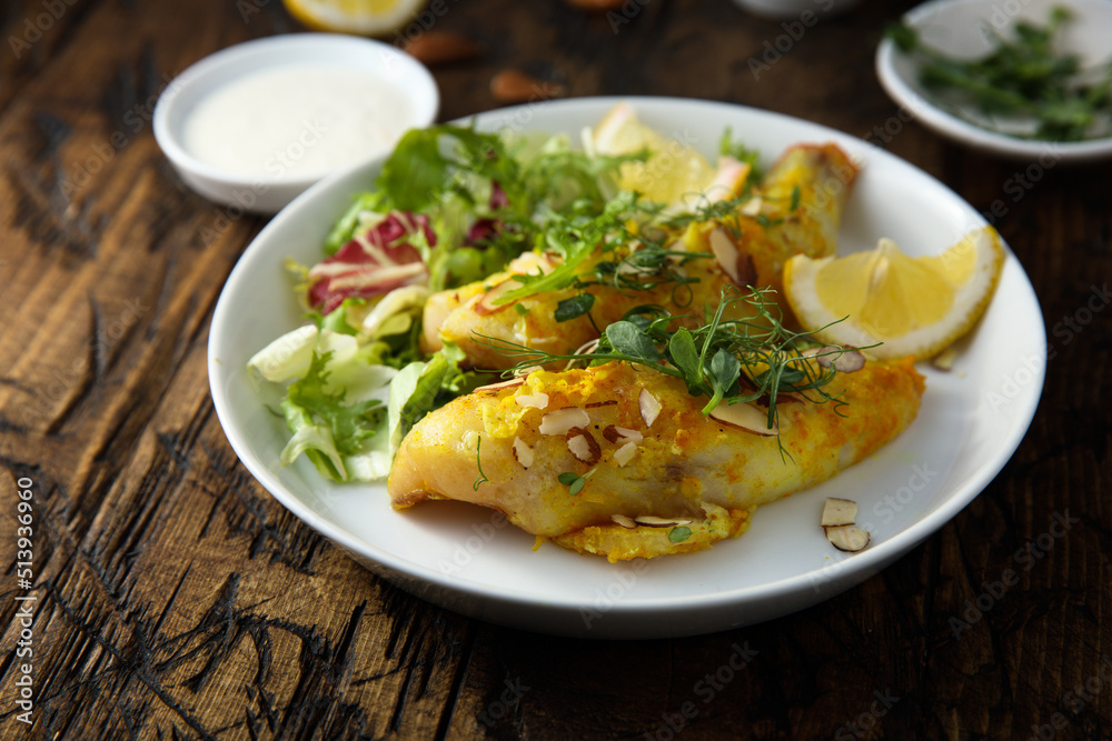 Roasted fish with almond flakes