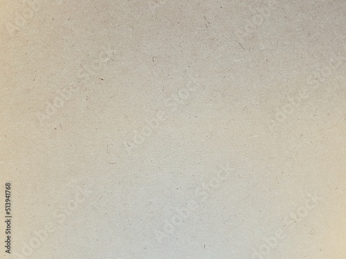 Brown paper texture and grain for aesthetic of autumn and fall design. Color and light gradient on warm earth tone paper background.