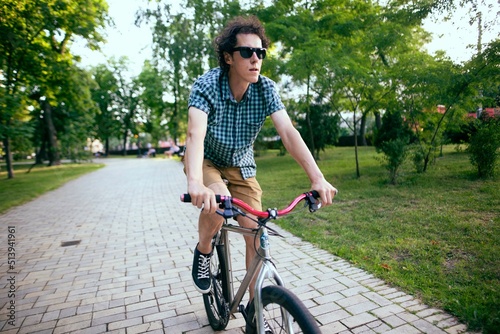 Cyclist riding in a city park.