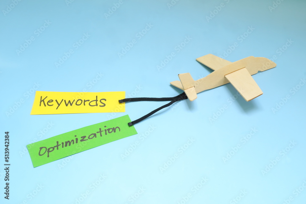 Keyword and Search Engine Optimization or SEO importance and key for success concept in business marketing. Airplane model carrying paper banner.