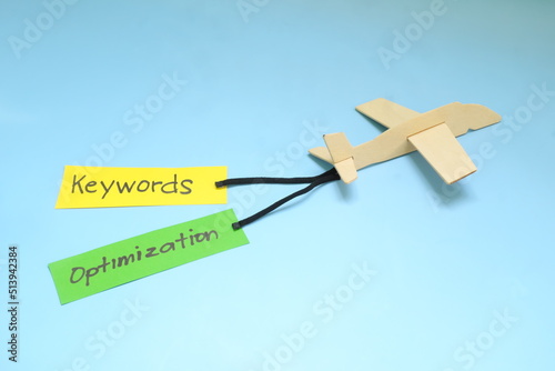 Obraz na płótnie Keyword and Search Engine Optimization or SEO importance and key for success concept in business marketing. Airplane model carrying paper banner. w salonie
