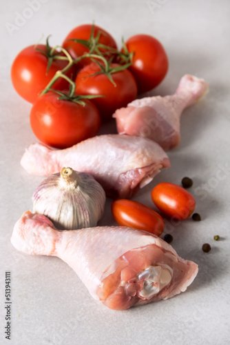 Fresh Chicken Meat on Gray Background Raw Tomatoes Pepper Ingredients for Healthy Dinner Vertical