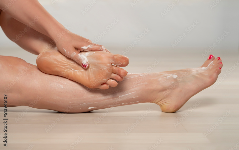 Woman applying body lotion on her legs, isolated. Woman applying body lotion on her legs, isolated.