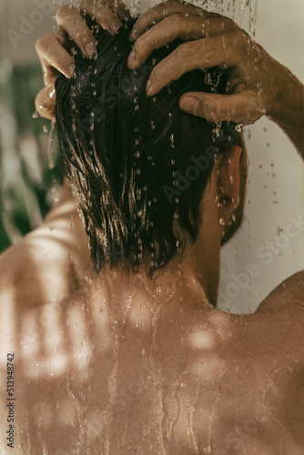 Young man having a shower outdoors.