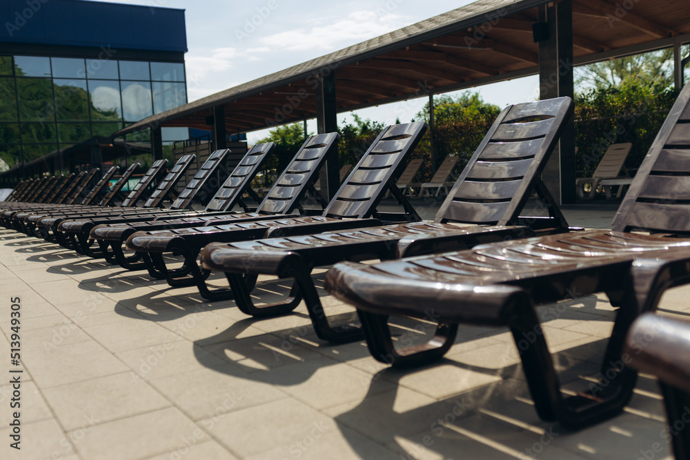 sunbeds by the swimming pool Stock Photo | Adobe Stock