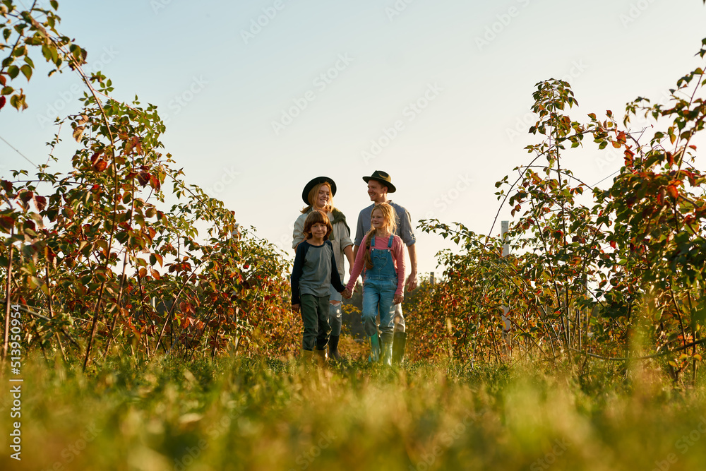 Bottom view of family walk in countryside garden