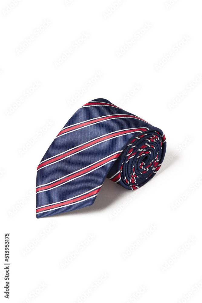 Fototapeta premium Close-up shot of an elegant blue tie with red and white stripes. The navy blue and red striped tie is rolled and isolated on a white background. Top view.