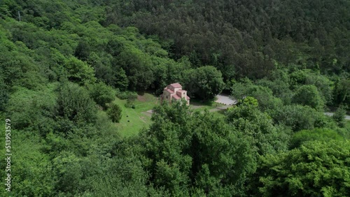 San Miguel De Lillo pre romanesque historical church in middle of forest in Asturias, Spain. Aerial photo