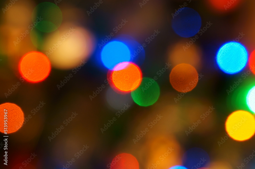 Abstract blurred background. Christmas tree toys and glowing garlands on the Christmas tree.