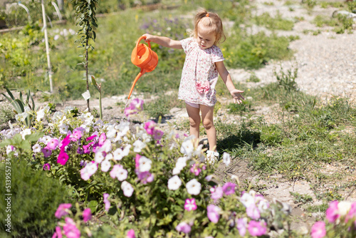 Baby watering the flowers with a watering can