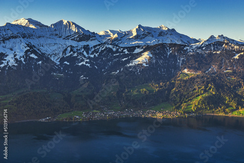 The snow-covered Swiss Alps and the view of Thun lake.