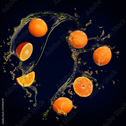 Fototapeta Naklejka Na Ścianę i Meble -  Juicy delicious orange with splashes of juice background for designers