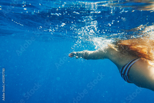 Shot of an unrecognisable woman swimming in the Mediterranean Sea in Italy