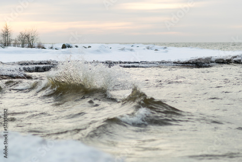 winter landscape from the sea shore, blurred wave slag against frozen ice cubes, blurred background