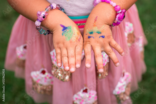 Shimmering sparkling glitter tattoo on a child's hand at a birthday party