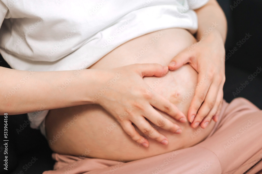 Close up healthy Stomach woman hands made heart