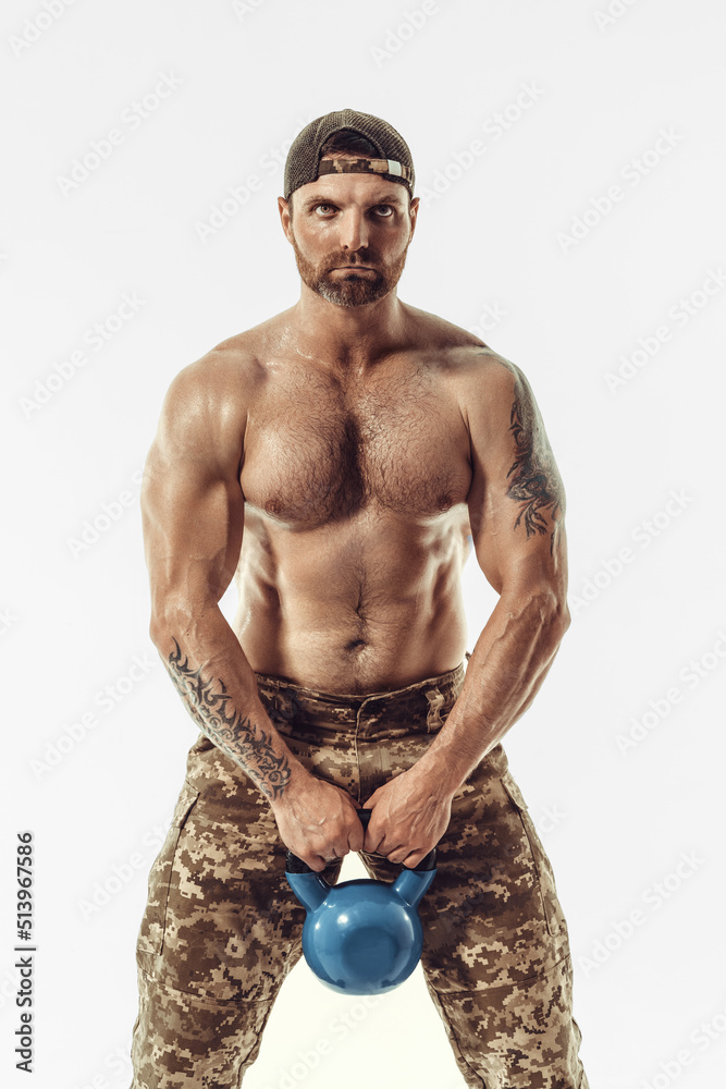 Fototapeta premium Muscular and fit young bodybuilder fitness male model posing over white background. 