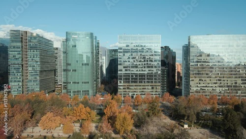 Aerial View Of Araucano Park In Autumn Colors Alongside Modern Glass Buildings In Santiago, Chile. - Aerial photo