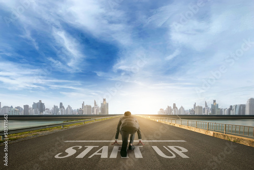 businessman person ready to run START UP toward the city. Business start-up concept.