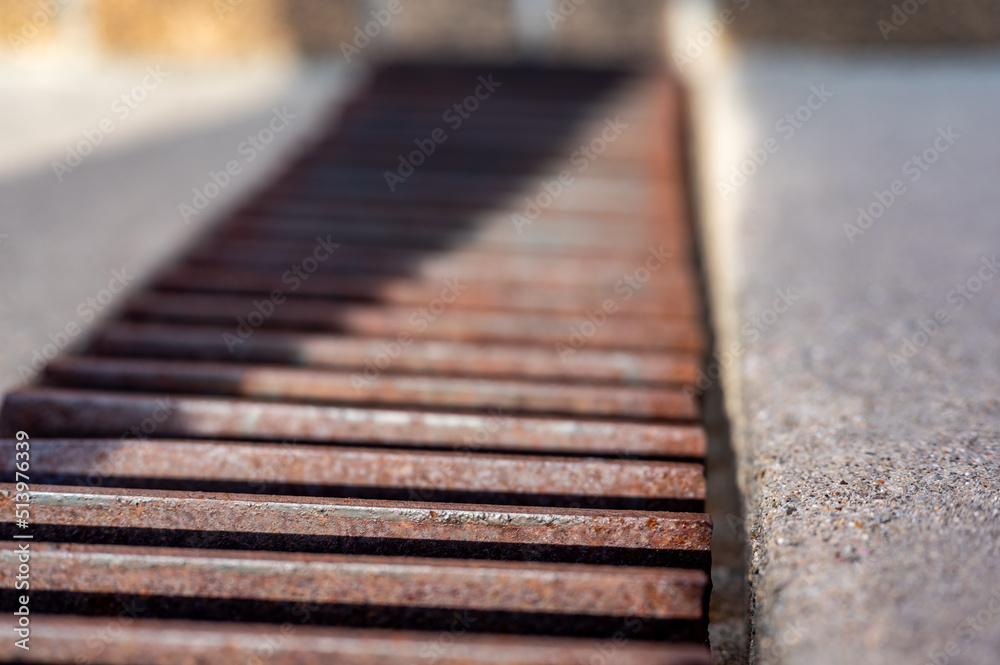 Grate over a stormwater trench in a concrete slab. Grate over a stormwater trench in a concrete slab.