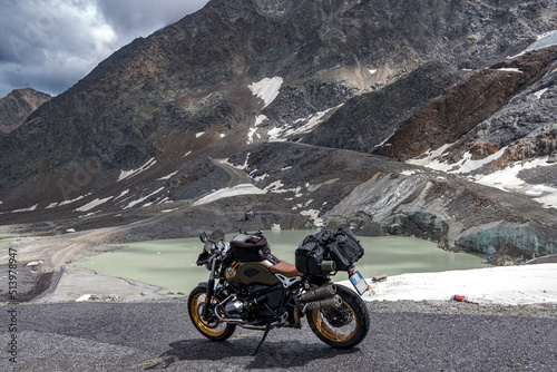 Mountain landscape with melted glacier and motorcycle