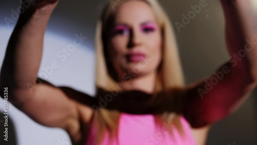 The blonde breaks a chicken egg on camera and smiles at the end.Close-up of the object, the girl is out of focus.Slow motion