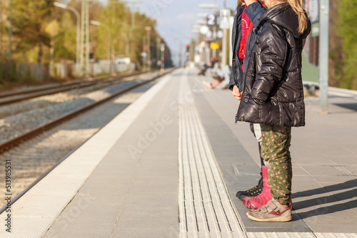 Safe Travel with Children in Europe. Children on Railway Station waiting Train. Safe Family Travel  by Public Transport. © Maryana