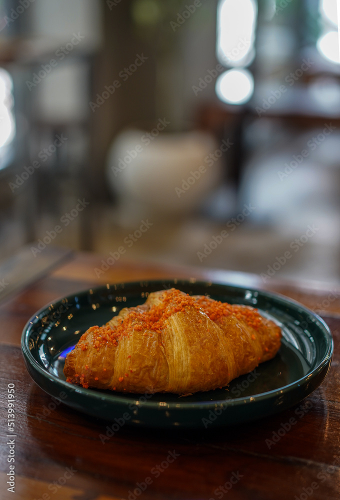 salted egg croissant on the plate salted egg croissant on the plate