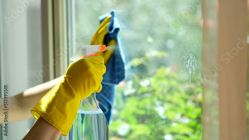 фотографія Hands in gloves wash window with rag