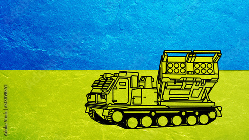 MLRS M270 Multiple Launch Rocket System for Ukraine in Lend Lease is shown on Ukrainian flag. photo