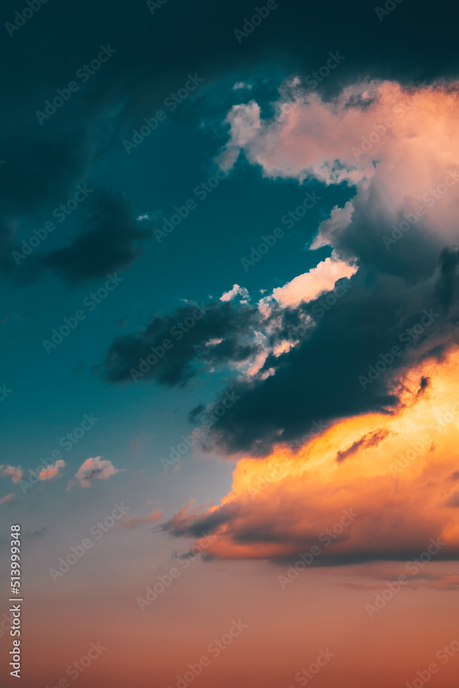 Beautiful evening sky with multi-colored bright clouds. Rain clouds at sunset. High-quality photo