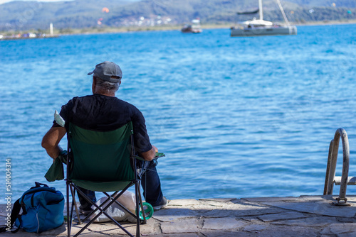 old man fishing by the sea