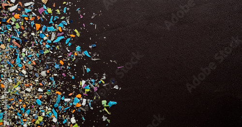 Close-up on micro plastic particles. The concept for water pollution and global warming. Macro shot on a bunch of microplastics that cannot be recycled.