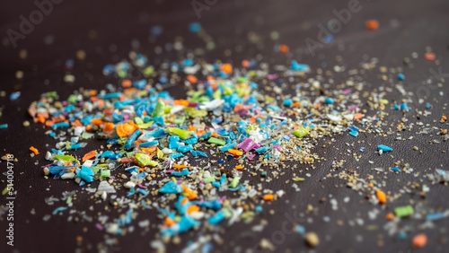 Close-up on micro plastic particles. The concept for water pollution and global warming. Macro shot on a bunch of microplastics that cannot be recycled.