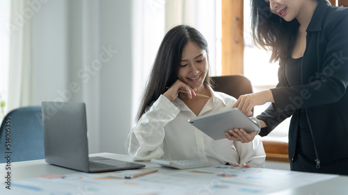 Asian business adviser meeting to analyze and discuss the situation financial report on digital tablet. Investment Consultant, Financial Consultant, Financial advisor and accounting concept