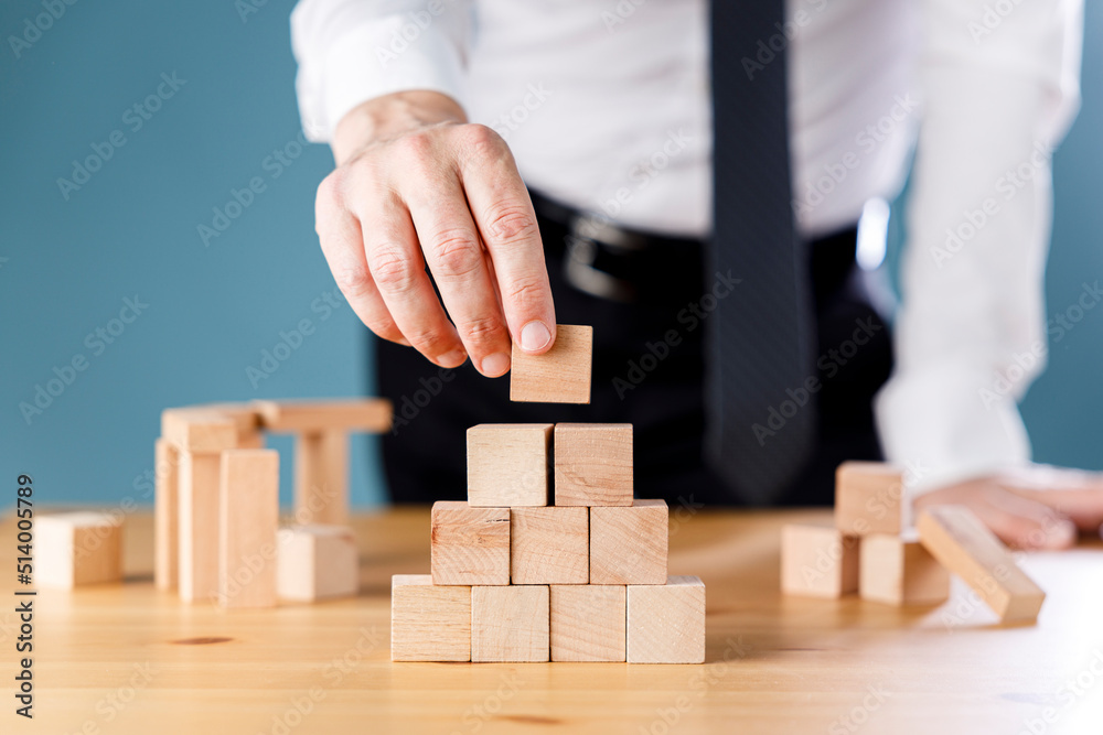 Close up shot of a businessman building cube blocks. Business concept growth success process. Close up shot of a businessman building cube blocks. Business concept growth success process.