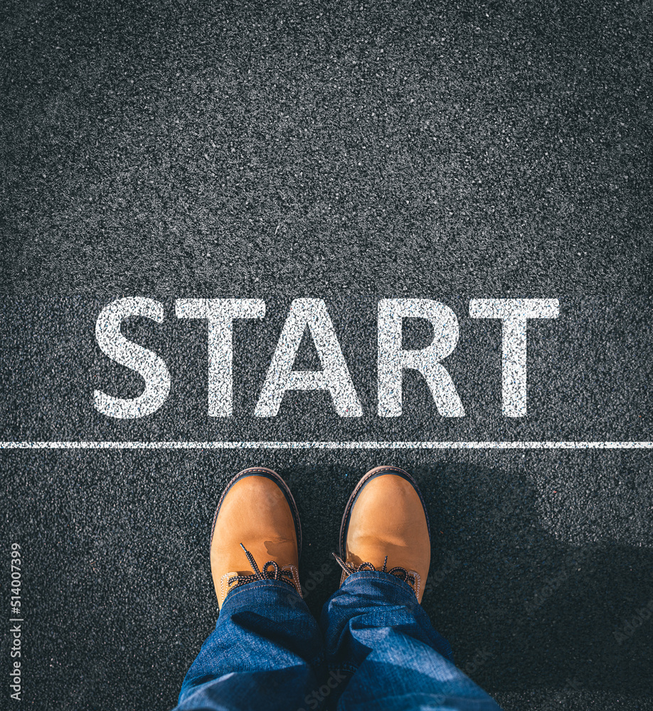 The Start inscription on the asphalt. The man in boots takes a step.